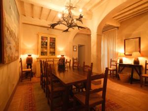 a dining room with a long table and chairs at Castello di Fighine in San Casciano dei Bagni