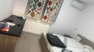 a room with a bed with a laptop on it at Szirom apartman in Szeged