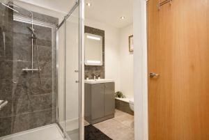 a bathroom with a shower and a sink at The MCR Prime Pad in Manchester