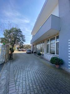 a car is parked outside of a building at Hotel Restaurant Deso in Shijak