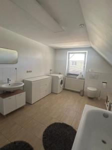 a white bathroom with a sink and a toilet at Sonnennest am Stadtrand in Schwerin +23 photos