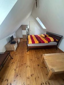a bedroom with a bed and a wooden floor at Sonnennest am Stadtrand in Schwerin