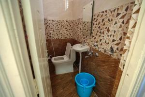 a small bathroom with a toilet and a sink at N Cube Serviced Apartments in Hyderabad