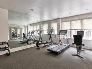a gym with treadmills and ellipticals and a mirror at AKA Rittenhouse Square in Philadelphia