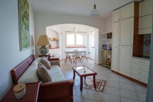 a living room with a couch and a table at L'Appartamentino in Casa Donato