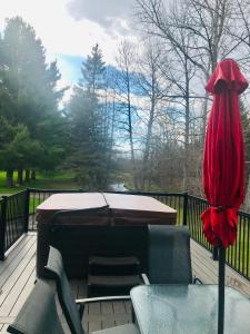 a deck with a piano and a table and chairs at Chalet Le RV 3 in Notre-Dame-Des-Bois +6 photos