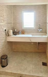 a bathroom with a large sink and a window at روز بيلا 1 Rosa Bella in Al Jināh +13 photos