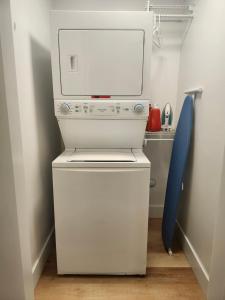 a small white washer and dryer in a room at Serene Luxury Suite in Riverview