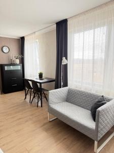 a living room with a couch and a table at Vienibas apartment in Daugavpils