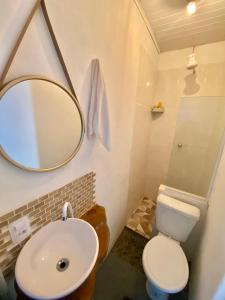 a bathroom with a sink and a mirror and a toilet at Hospedagem Mandala in Ubatuba +36 photos