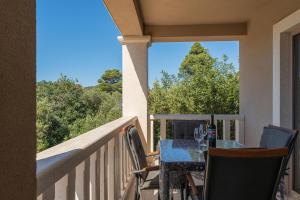 a table and chairs on a balcony with a view at Milina Residence - Lumbarda in Lumbarda