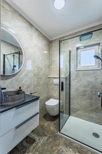 a bathroom with a glass shower and a toilet at Milina Residence - Lumbarda in Lumbarda +33 photos