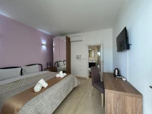 a hotel room with a bed and a television at Alina Boutique Living in Victoria +35 photos