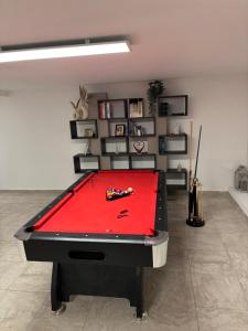 a pool table with a red cover in a room at Villa Champigny in Champigny-sur-Marne