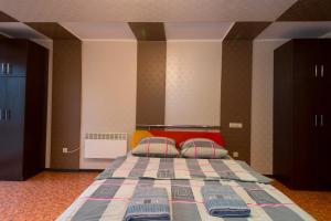 a bedroom with a bed with two pillows on it at Tiraspolska 2a Very center in Kherson