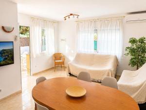 a living room with a table and a couch at Casa Mañet - "Pet Friendly - Piscina Privada - Playa - BBQ - Parking - Delta de l'Ebre - Riumar" in Riumar