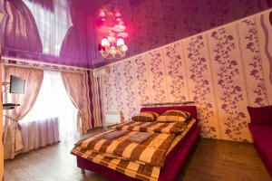 a bedroom with a bed in a room with purple walls at Central Supermarket Apartment 2019 in Kherson