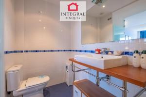 a bathroom with a sink and a toilet and a mirror at Infinite View Palamós in Palamós +15 photos