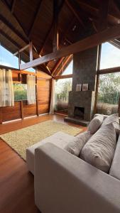 a living room with a couch and a fireplace at Lazer e descanso em Witmarsum in Palmeira +22 photos