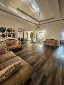 a large living room with two beds and a couch at Luxe Apartments in Lusaka