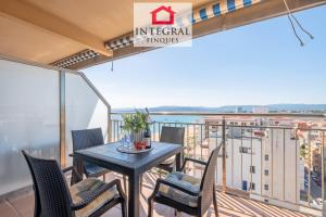 a balcony with a table and chairs and a view at Infinite View Palamós in Palamós