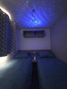 a bedroom with a bed with a starry ceiling at Les sables du midi in Valras-Plage