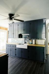 a kitchen with blue cabinets and a ceiling fan at Pine Creek Farm in Burkeville