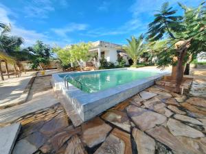 an image of a swimming pool in a villa at Bwereusunsetbungalow in Kidoti