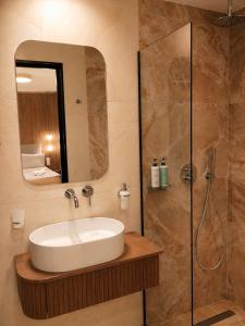 a bathroom with a sink and a shower at Morfeas City Hotel in Rhodes Town +23 photos
