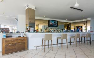 a bar with stools at a counter in a restaurant at Apollonium Bozbuk in Akbük