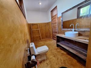 a bathroom with a toilet and a sink at Bwereusunsetbungalow in Kidoti +31 photos