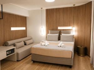 a bedroom with a bed and a couch at Morfeas City Hotel in Rhodes Town
