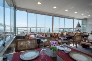 a restaurant with tables and chairs and windows at Oban Suites Istanbul in Istanbul