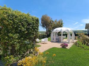 a garden with a white gazebo in the grass at Hotel La Siesta in Torino di Sangro