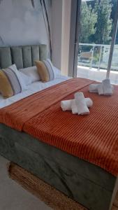 a large bed with two towels on top of it at Palm Forest Oasis in Mijas Costa +23 photos