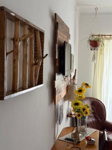 a living room with a table and a tv on a wall at Casa do Mar - Nazaré Big Wave Spotter House in Nazaré