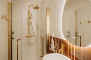 a bathroom with a shower and a toilet and a sink at Adishatz Motel in Biscarrosse +98 photos