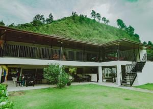 a large building with a hill in the background at Hotel Central Boquete in Boquete +58 photos