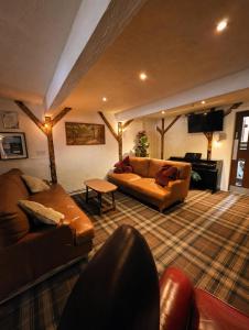 a living room with two couches and a tv at Grains Bar Hotel in Oldham