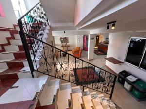 a staircase in a house with a living room at Hotel Gran Imperio la 69 in Medellín