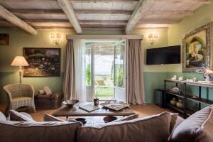 a living room with a couch and a table at Dimora Santa Margherita - Boutique Hotel in Cinigiano