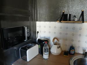 a kitchen counter with a toaster a toaster and a sink at Arthur et Eva - Lit King size - gare - centre - hopital in Abbeville