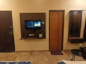 a room with a flat screen tv and a window at PVR Grand Residency in Tiruvannāmalai