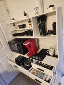 a kitchen pantry with white shelves and a coffee maker at Comfy hideaway in Hollywood