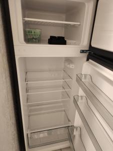an empty refrigerator with its door open at Comfy hideaway in Hollywood