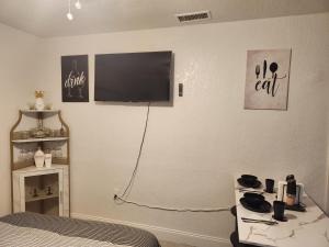 a bedroom with a bed and a television on the wall at Comfy hideaway in Hollywood