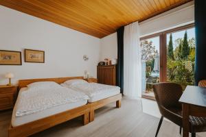 a bedroom with a bed and a large window at Pension Haus Elmar in Rösrath
