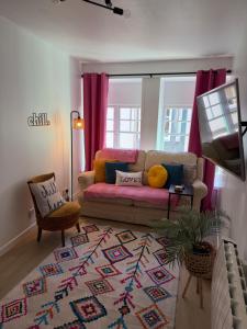 a living room with a couch and a rug at Well St Apartment in Moffat