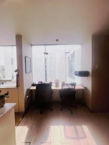 an office with a desk with two chairs and a window at Subvolcanic Point in Arequipa +17 photos