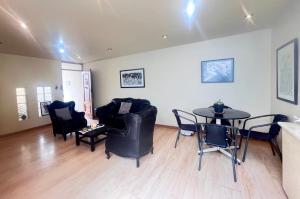 a living room with black chairs and a table at Subvolcanic Point in Arequipa